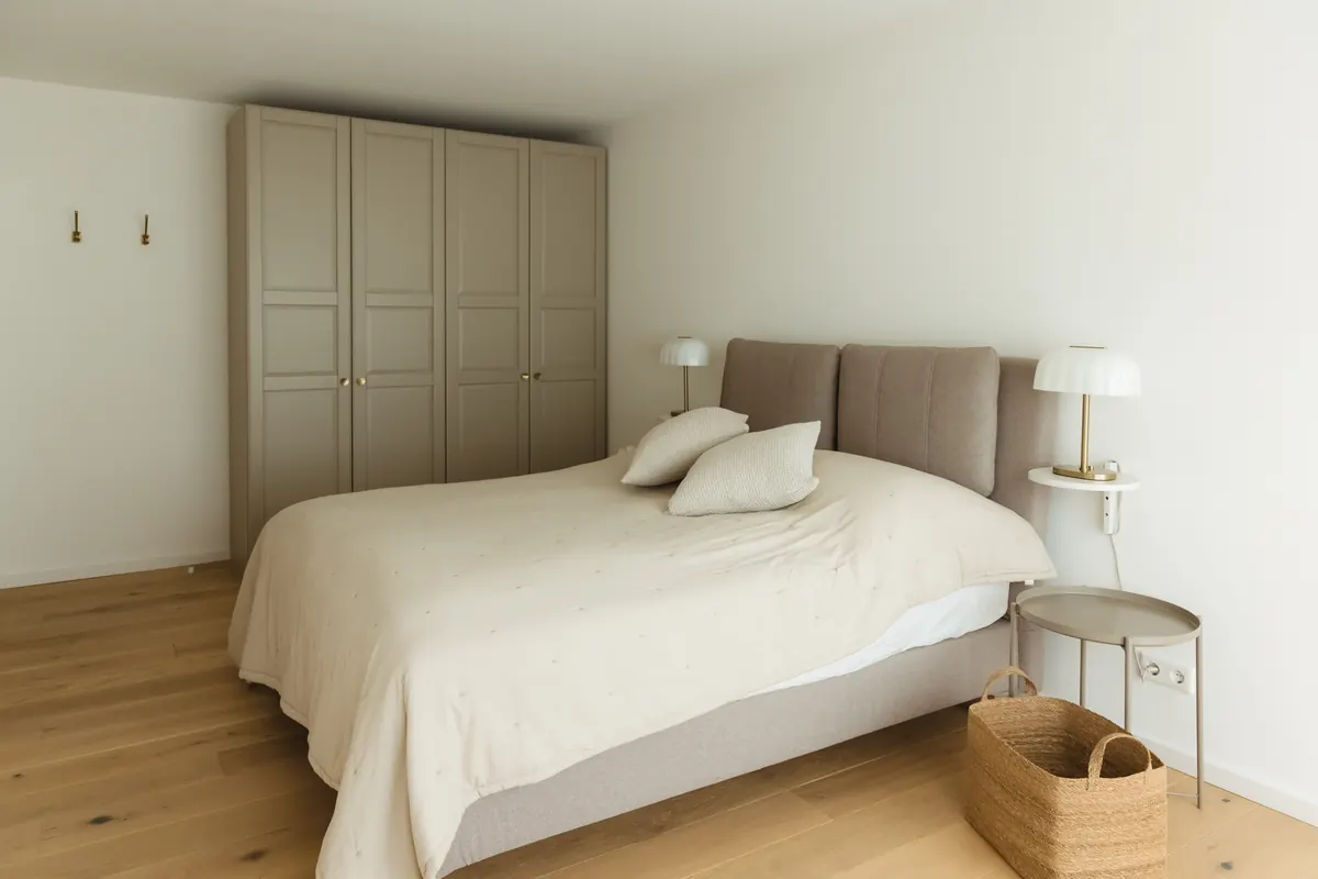 Spacious furnished bedroom with double bed and wardrobe